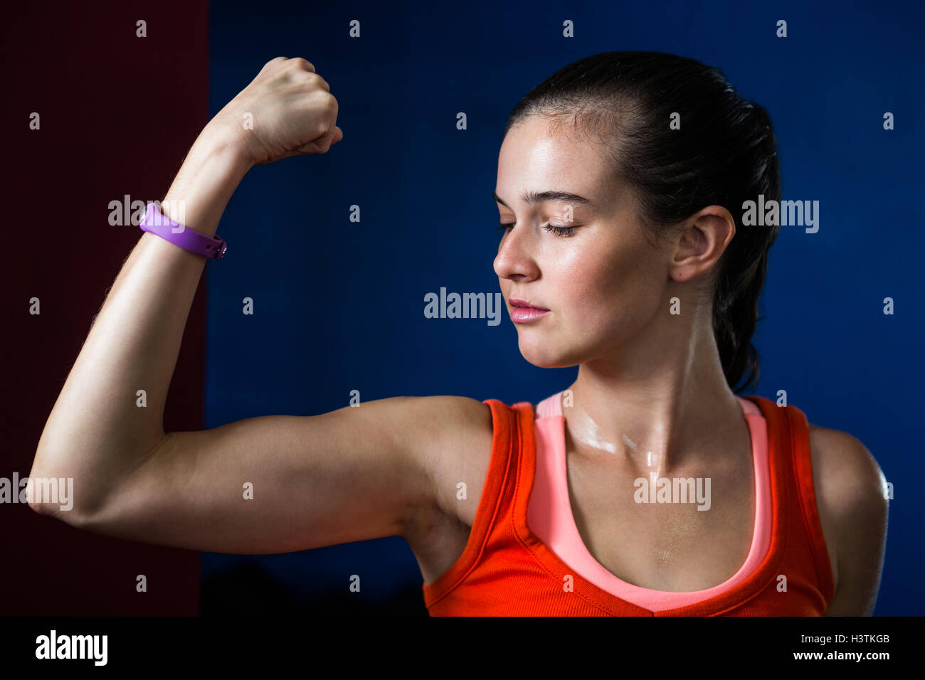 Close-up of woman flexing muscles in gym Stock Photo