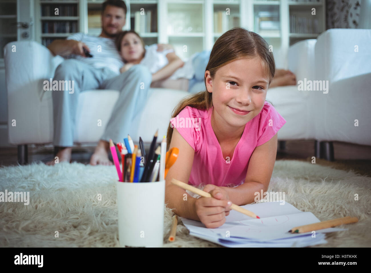 Girl lying on the floor and drawing Stock Photo - Alamy