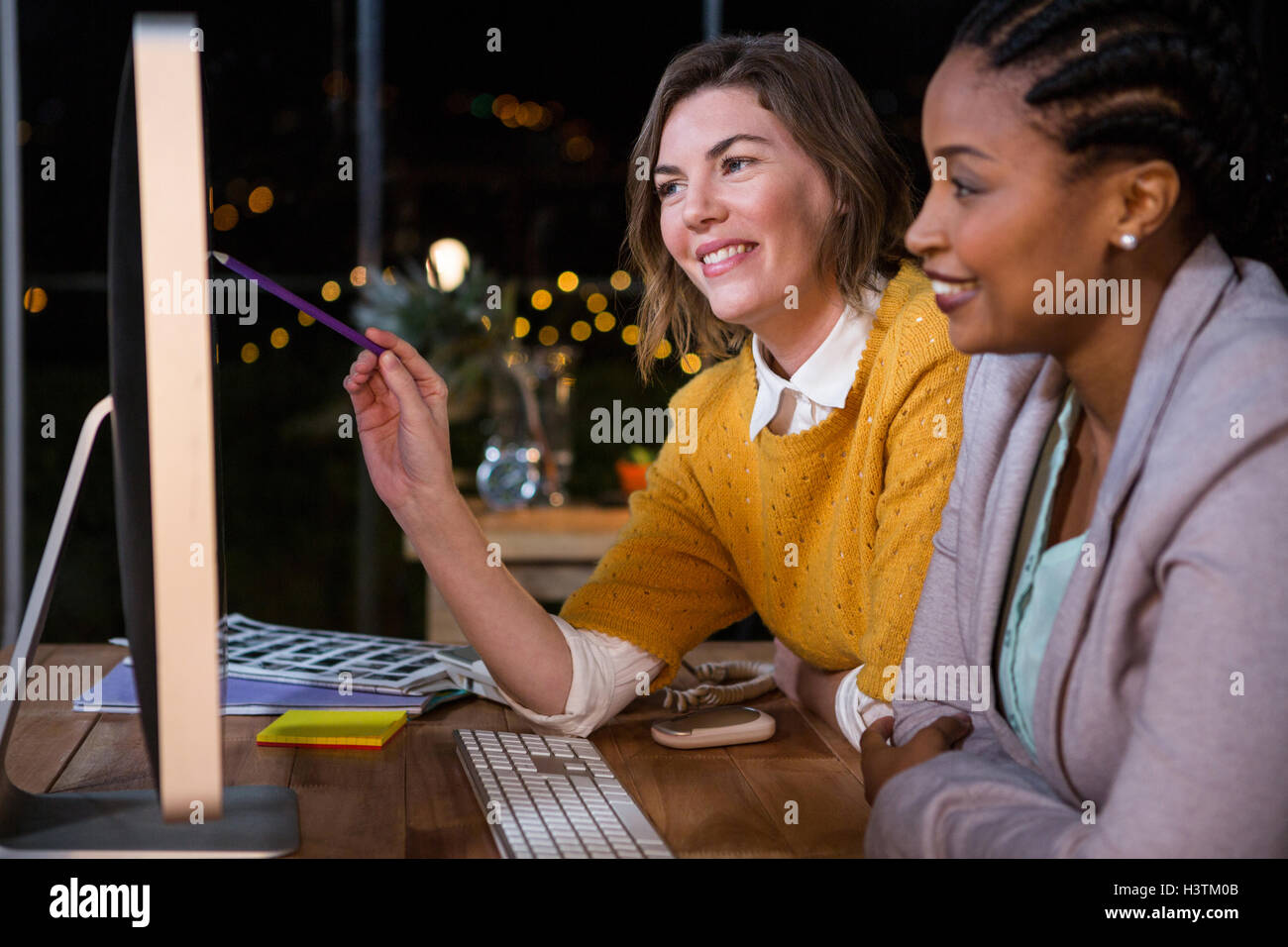 Businesswomen working on computer at their desk Stock Photo - Alamy