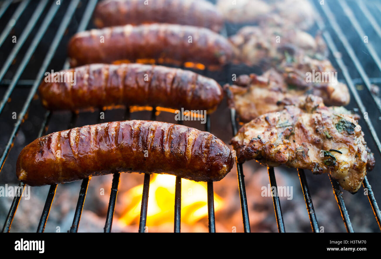 Fried pork sausages on a grill grid Stock Photo Alamy