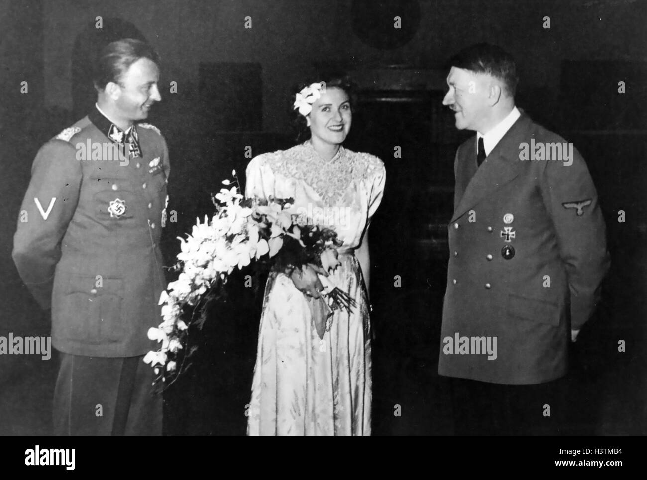 HERMANN FEGELEIN (1906-1945)  at left with his new wife  Gretl Braun, sister of Eva, and Hitler 3 June 1944 Stock Photo