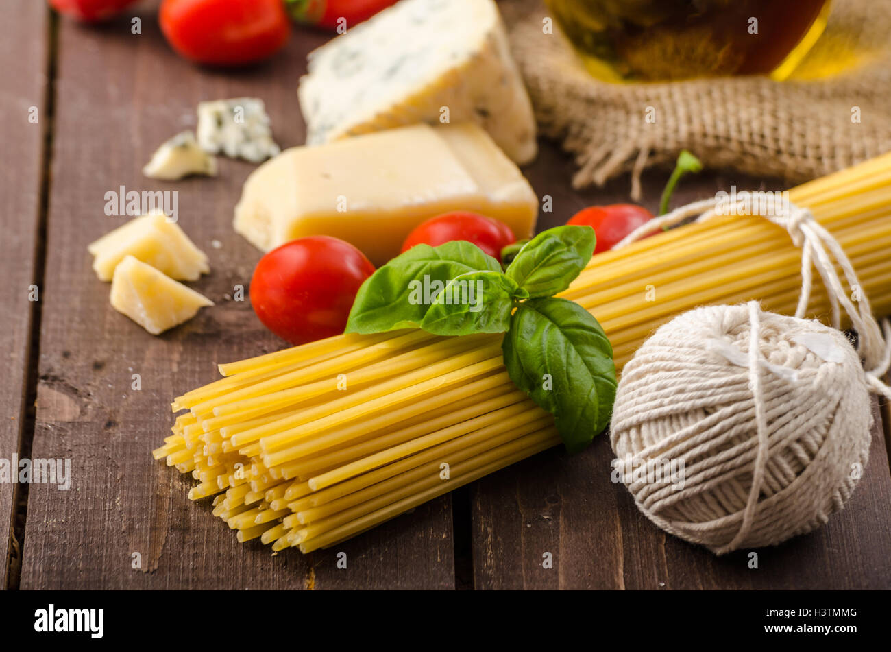 Still life photo, background with pasta and cheese, delicious san marzano tomatoes, place for your advertising Stock Photo