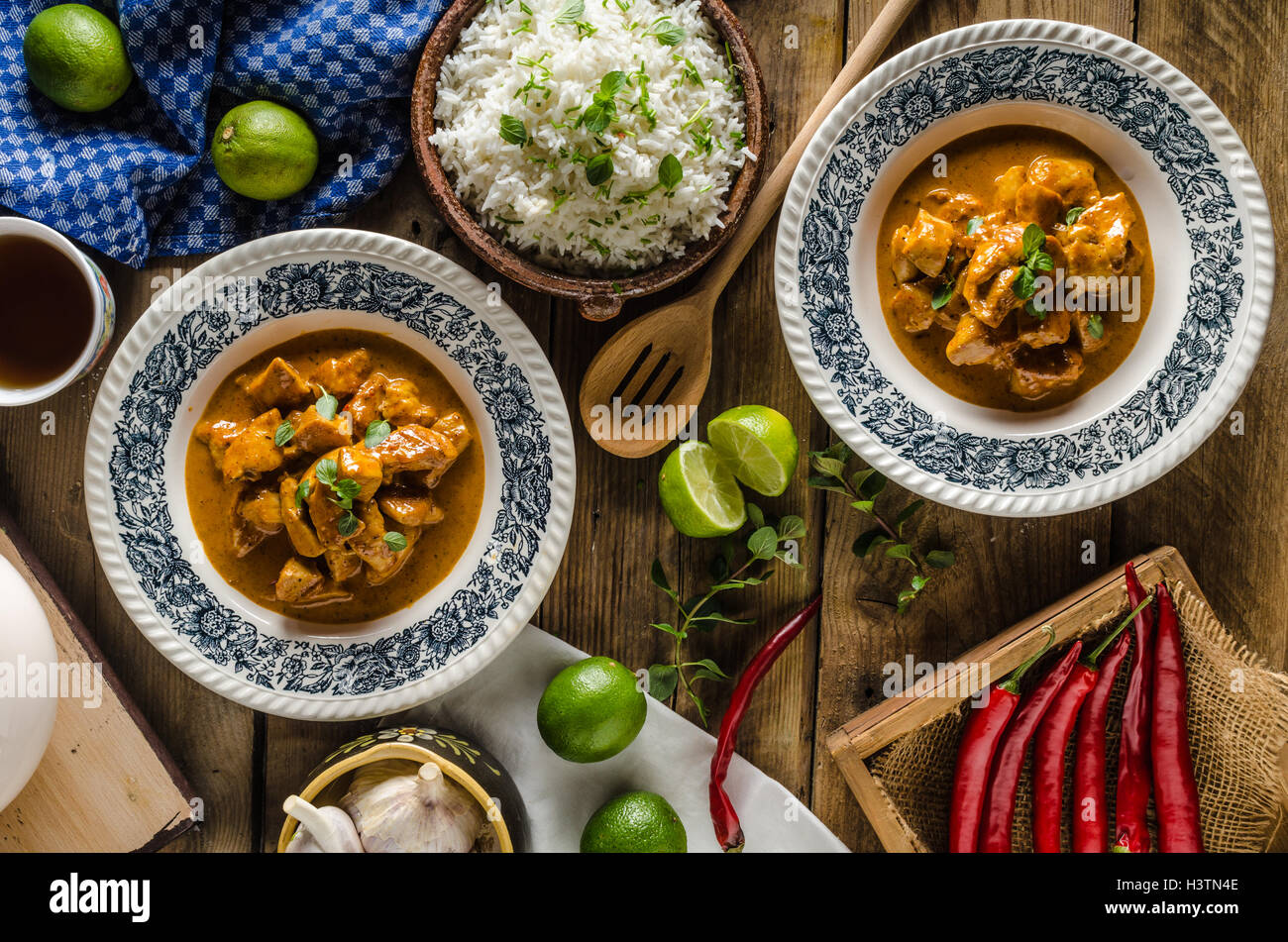 Curry chicken with basmati rice, delicious and spicy food, fresh herbs