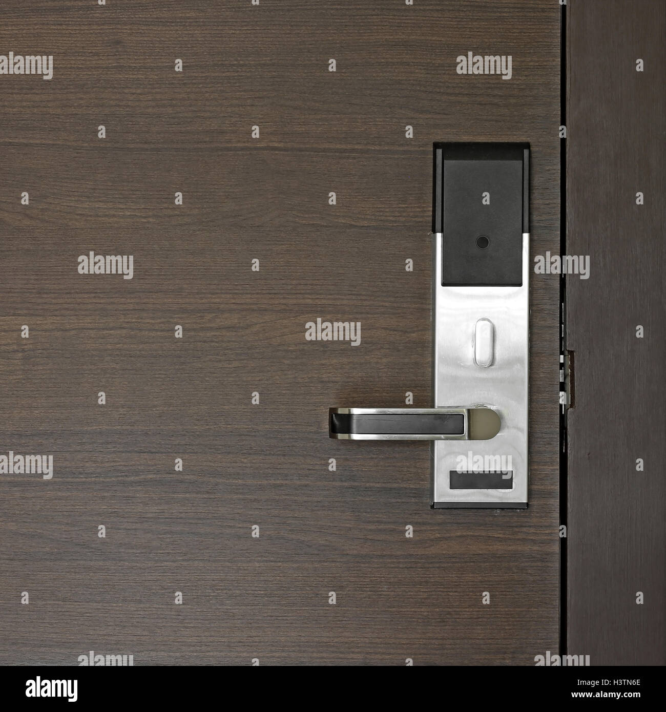 hotel electronic card lock on wooden door Stock Photo
