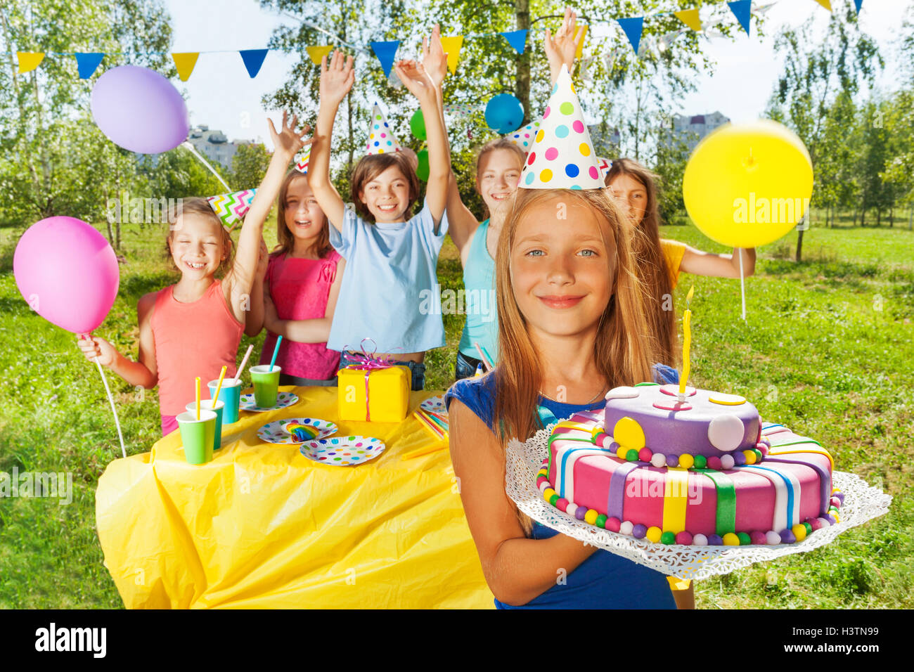 Happy young girl holding birthday cake with candle Stock Photo Alamy