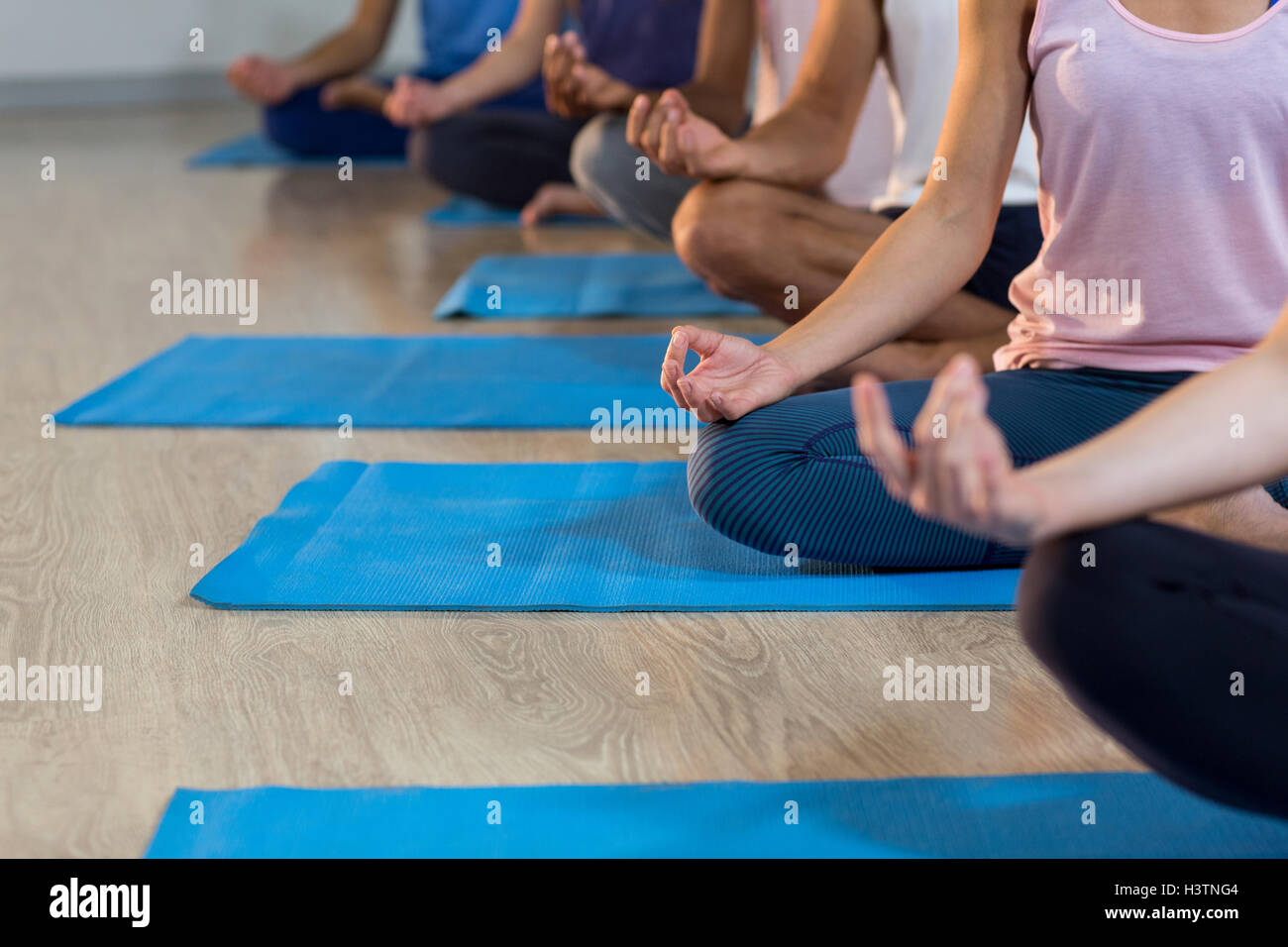 Group of people performing yoga Stock Photo - Alamy