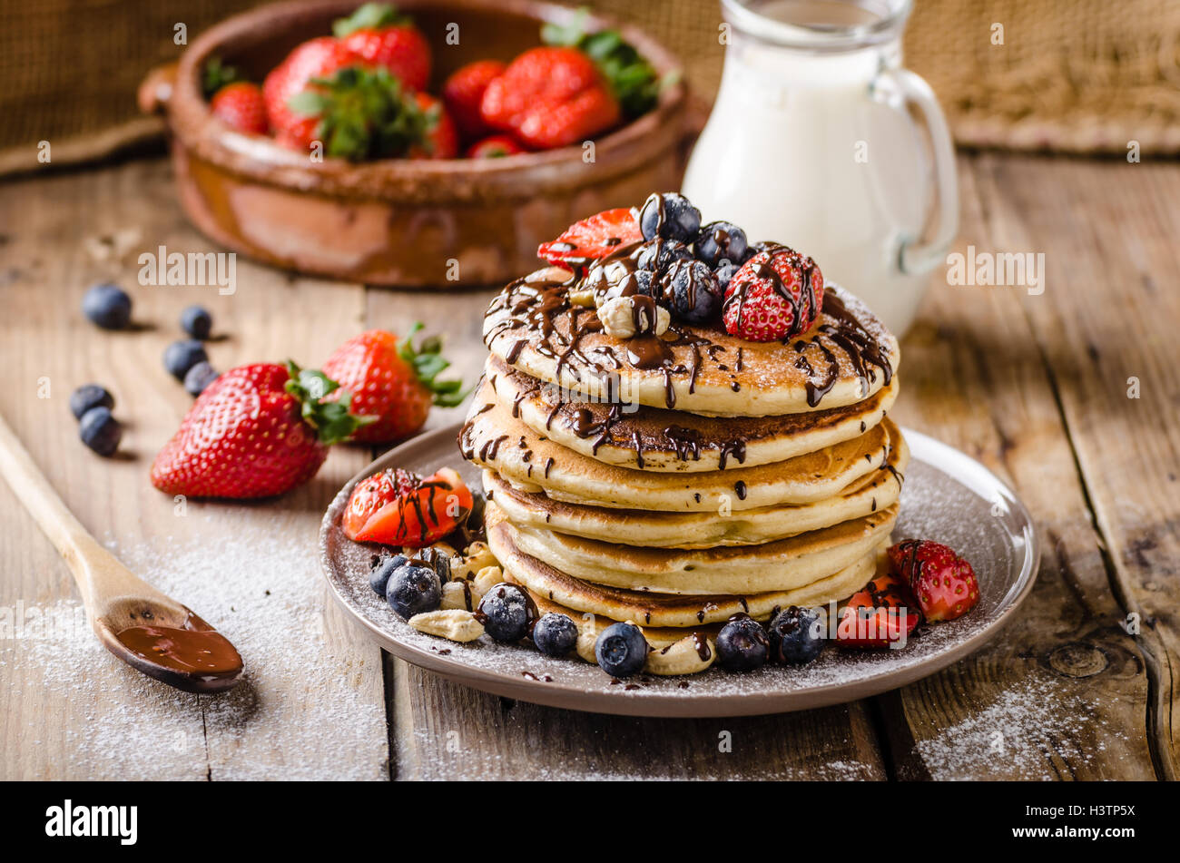 Original american pancakes with berries, roasted nuts and milk Stock ...