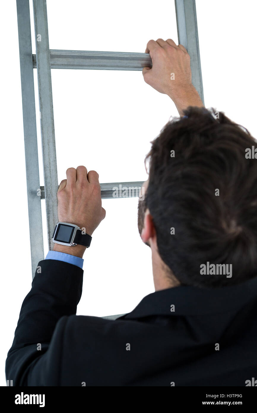 Businessman climbing ladder Stock Photo