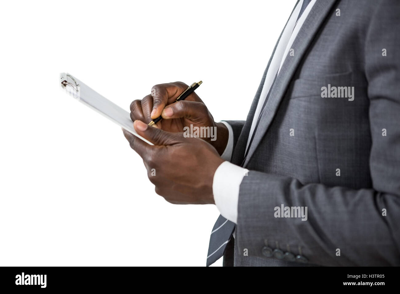 Businessman writing on clipboard Stock Photo - Alamy