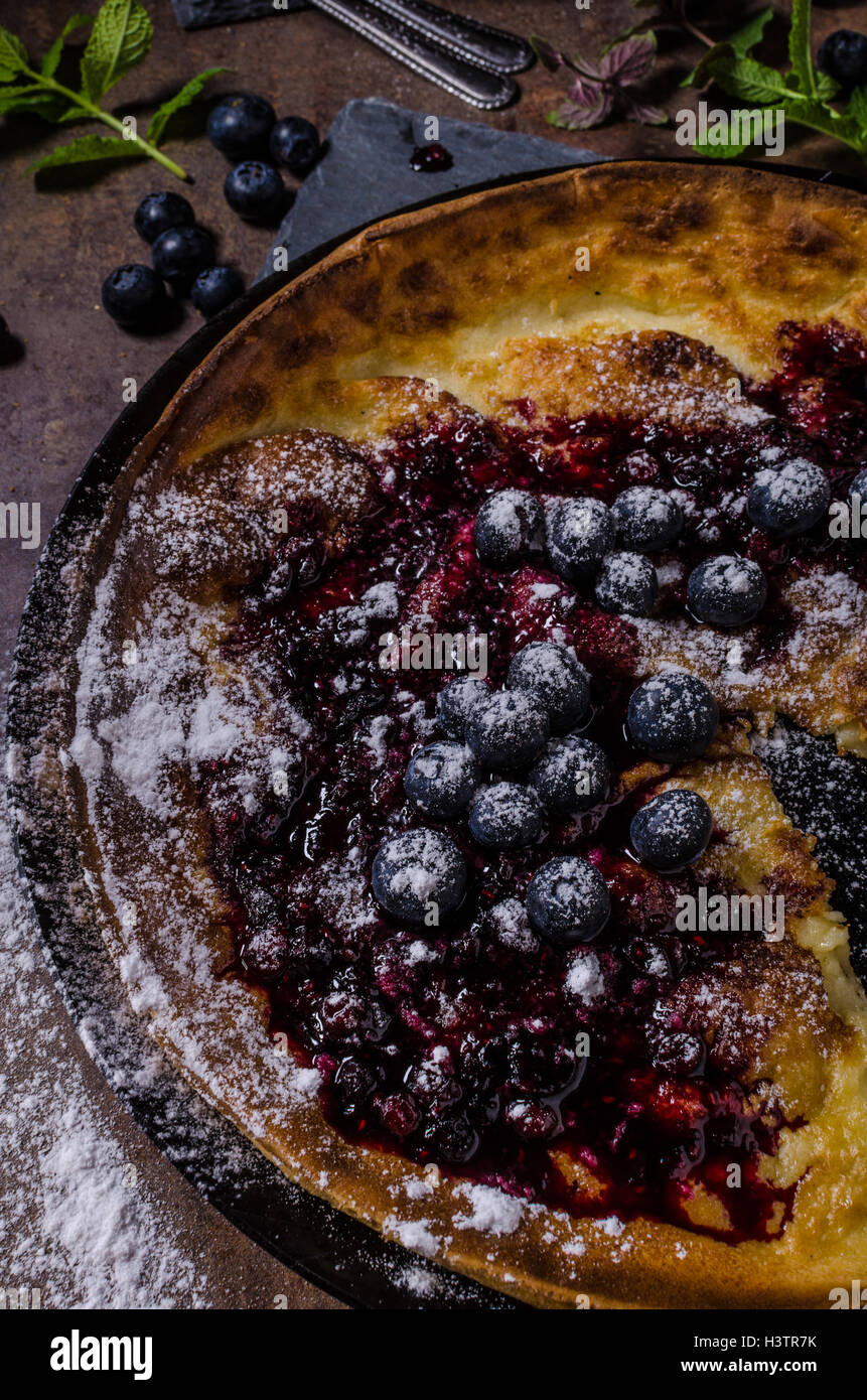 Dutch style pancake named dutch baby, baked in oven on iron skillet