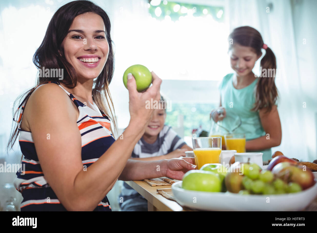 Smiling family having a breakfast Stock Photo - Alamy