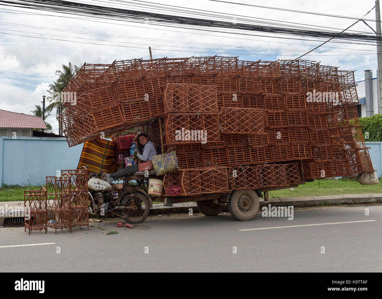 Motorcycle with fully loaded trailer, loaded with shelves, Phnom Penh, Cambodia Stock Photo