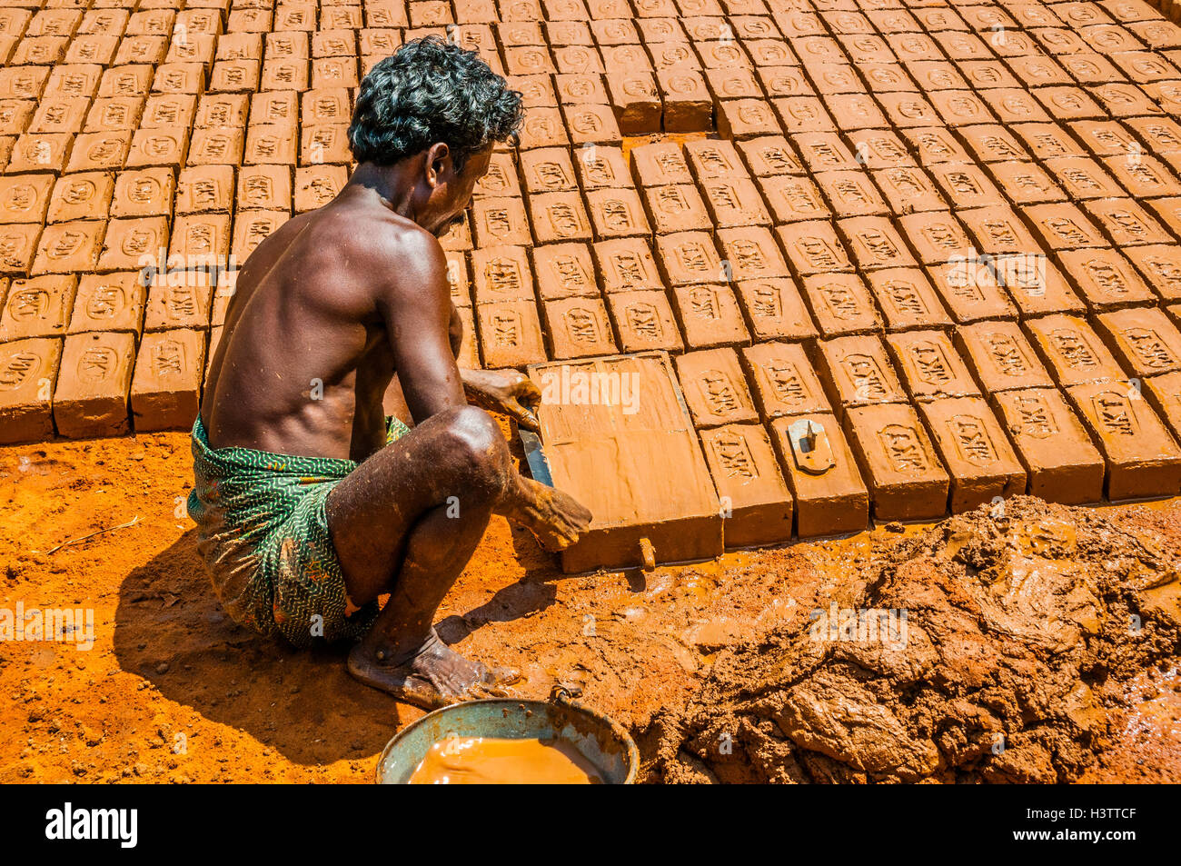 Indian man making clay bricks, Usilampatti, Tamil Nadu, India Stock Photo