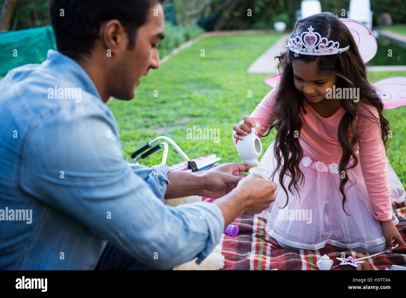 Father and daughter having toy tea party Stock Photo - Alamy