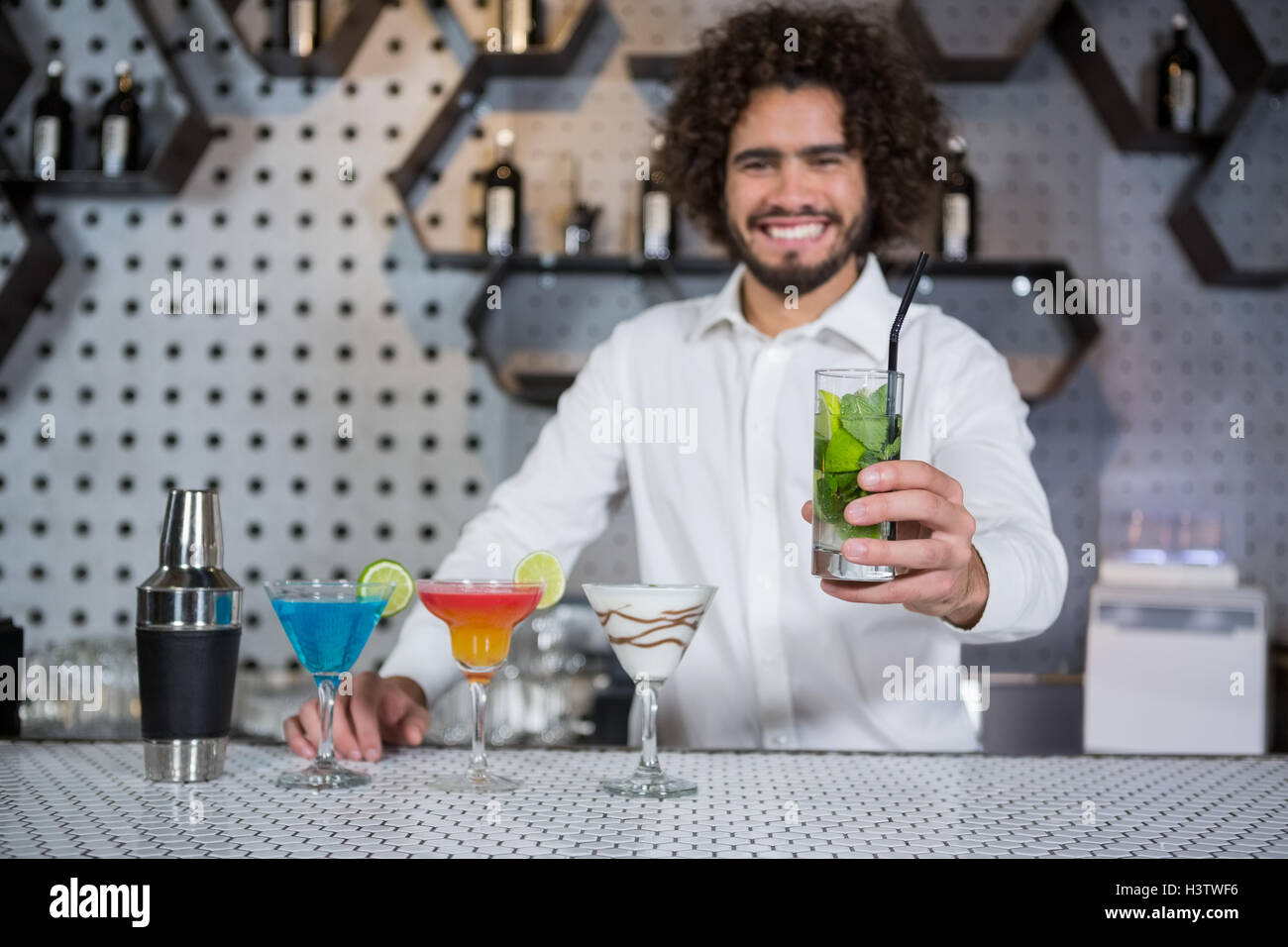 Bartender serving glass of gin Stock Photo