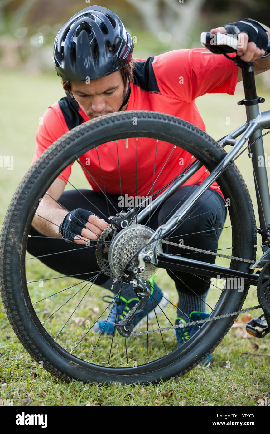 Male mountain biker fixing his bike chain Stock Photo Alamy