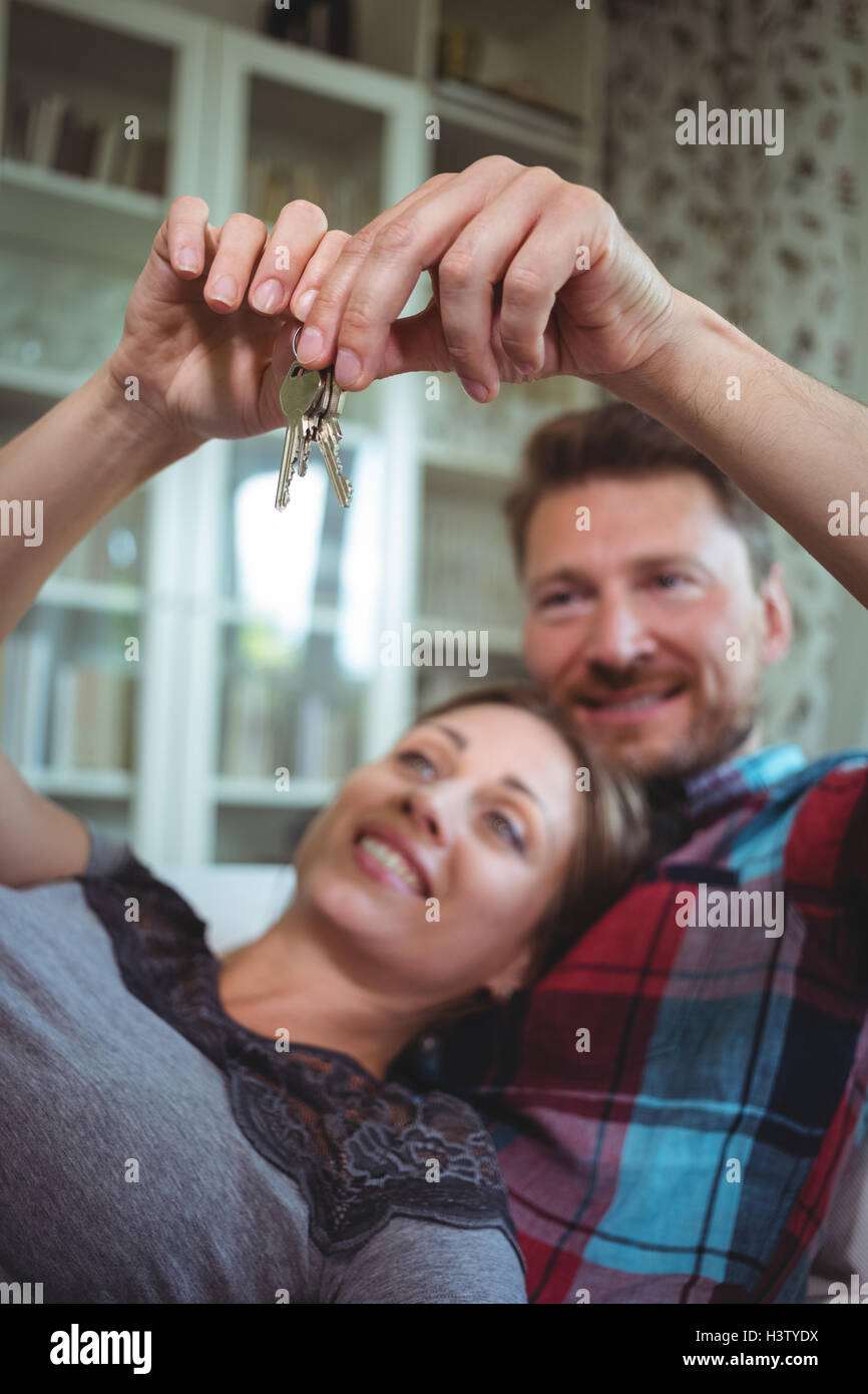 Happy couple holding their house key Stock Photo Alamy