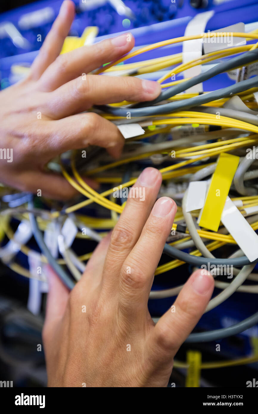 Technician checking cables in a rack mounted server Stock Photo Alamy