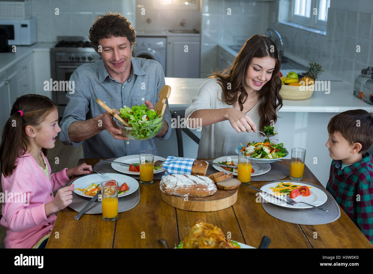 Happy family having breakfast Stock Photo - Alamy