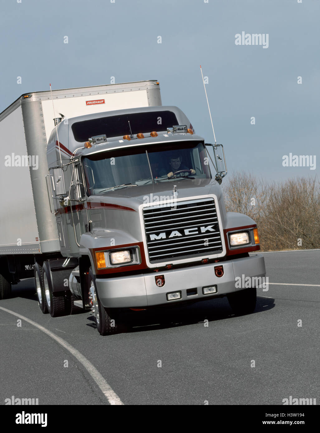 1982s 1990s SILVER CH-600 MACK TRUCK ON HIGHWAY TARMAC Stock Photo