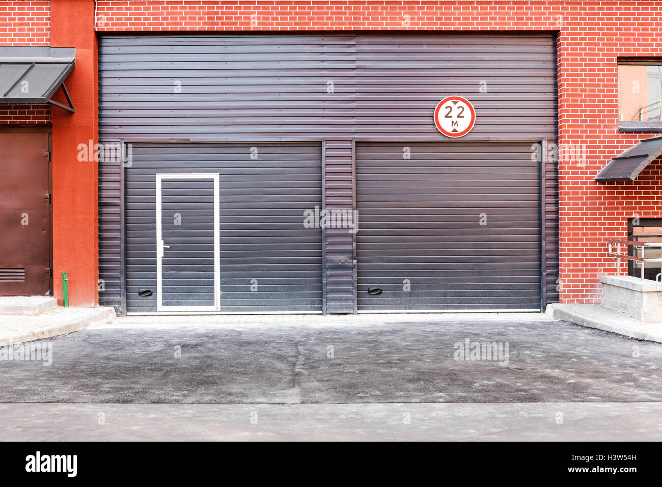 closed brown corrugated metal gate, wall of warehouse front view Stock Photo