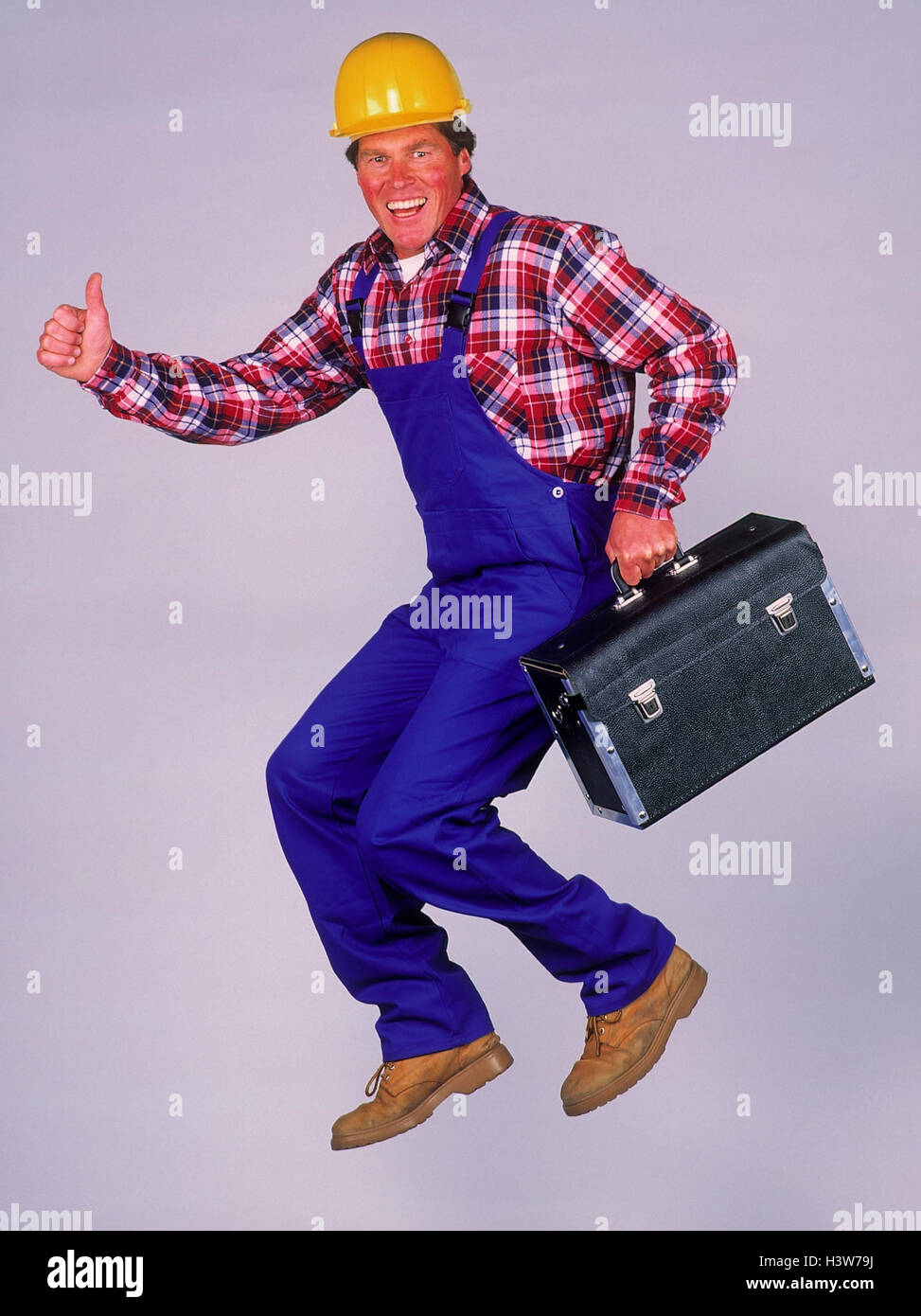 Craftsman, construction helmet, tool bag, gesture, pollex high, caper worker, construction worker, safety helmet, hard hat, overall, working trousers, pouch, OK, okay, in order, joy, crack, occupation, inside, studio, cut out Stock Photo