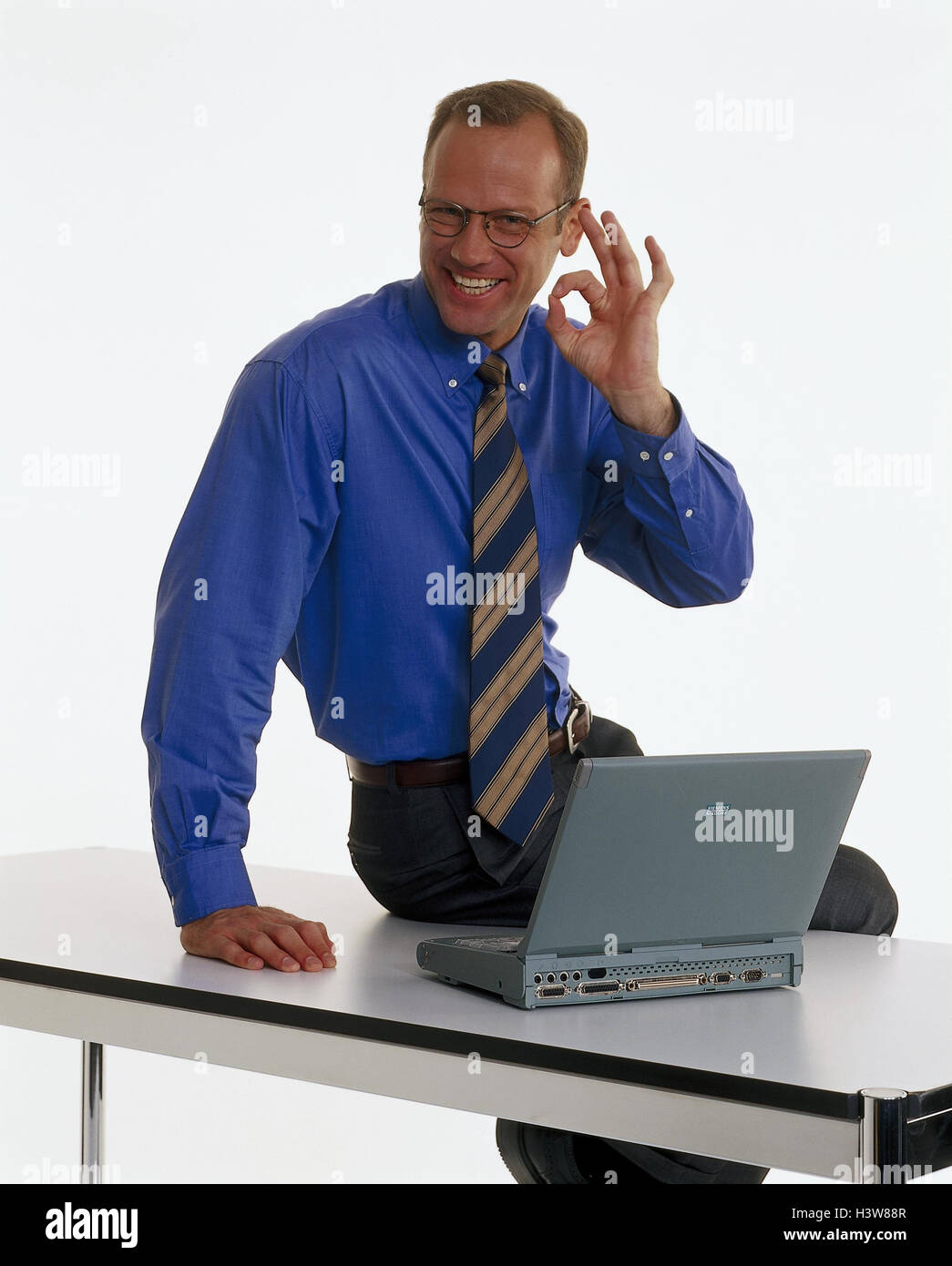 Businessman, young, laptop, gesture, perfectly, table, sit, professions, studio, cut out, notebook computer, successfully, enthusiasm, enthusiastically, completely, joy, Stock Photo