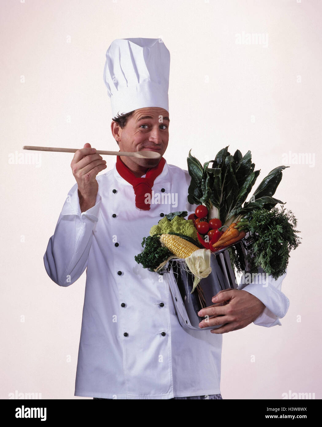 Cook, pot, vegetables, wooden spoon, gesture, half portrait, man, working clothes, occupation, gastronomy, try, ingredients, studio, cut out Stock Photo