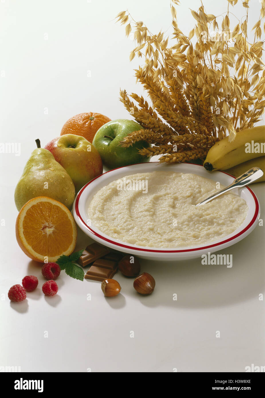 fresh fruit, grain, nuts, chocolate, plate with porridge cereals Stock Photo