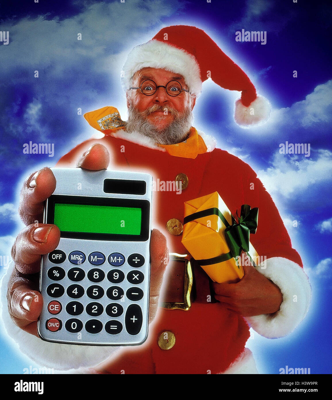 Santa Claus, electronic calculator, present, gesture, [M], Christmas,  Santa, Christmas present, expenses, outputs, calculation, calculation,  point, present, show, studio, Composing, half portrait Stock Photo - Alamy