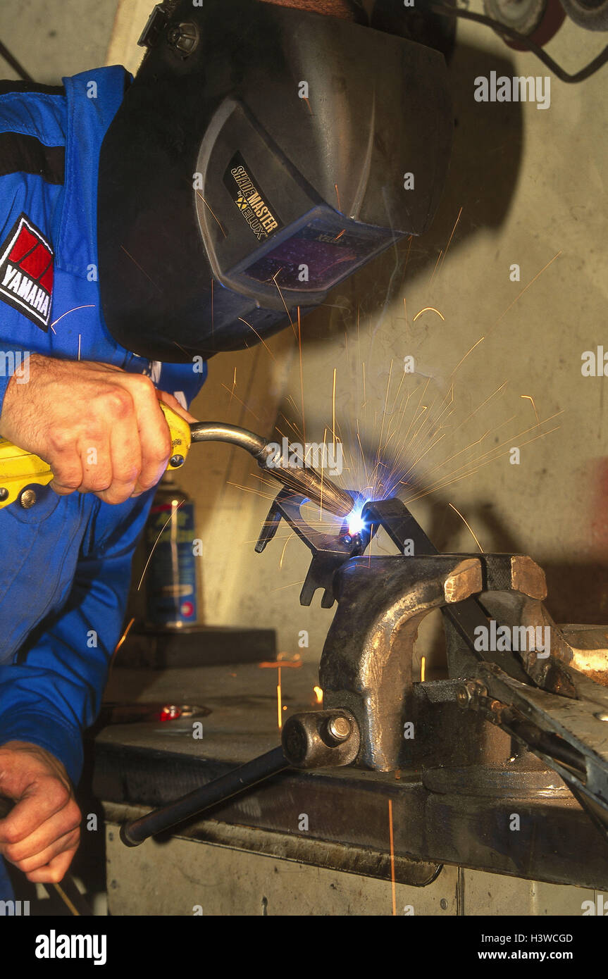 Garage, man, protective mask, metal, weld, sparking desk, vice, edit, there work, protective clothing, sparks Stock Photo