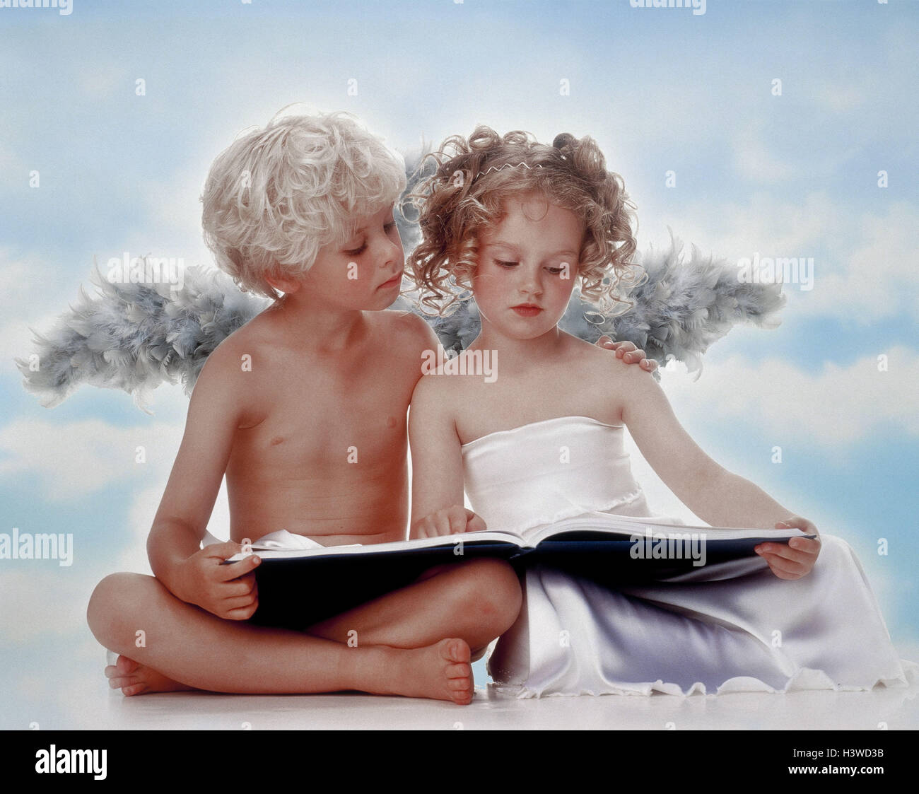 Boy, girls, angels, sit, read book, x-mas, Christmas, children, two, curls, lining, wing, angel's wing, cross legged, heaven messenger, studio, cloudy sky X MAS folder, Stock Photo