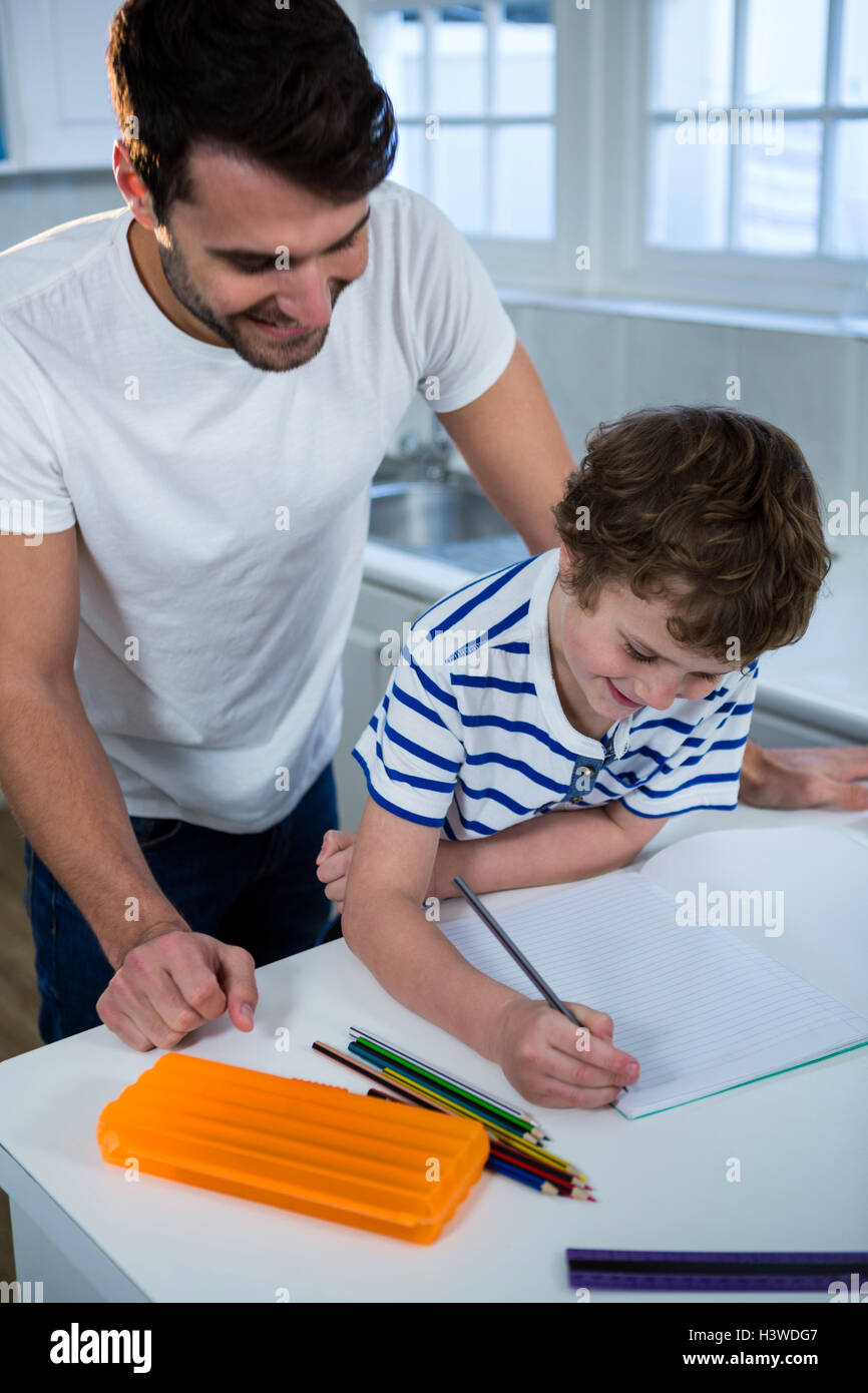 Father helping son with homework Stock Photo - Alamy