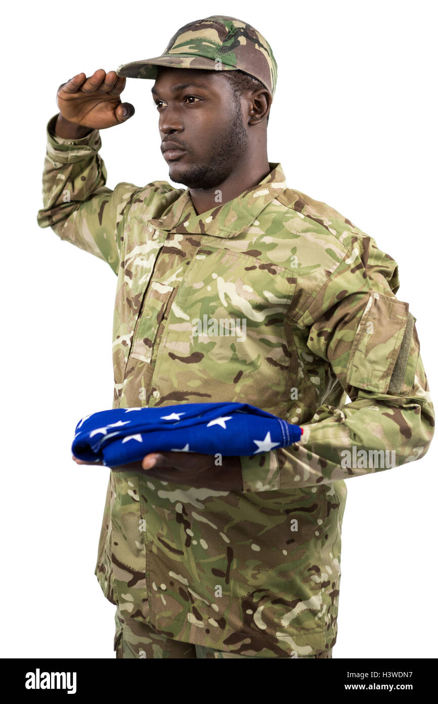Portrait of soldier holding an american flag and saluting Stock Photo ...