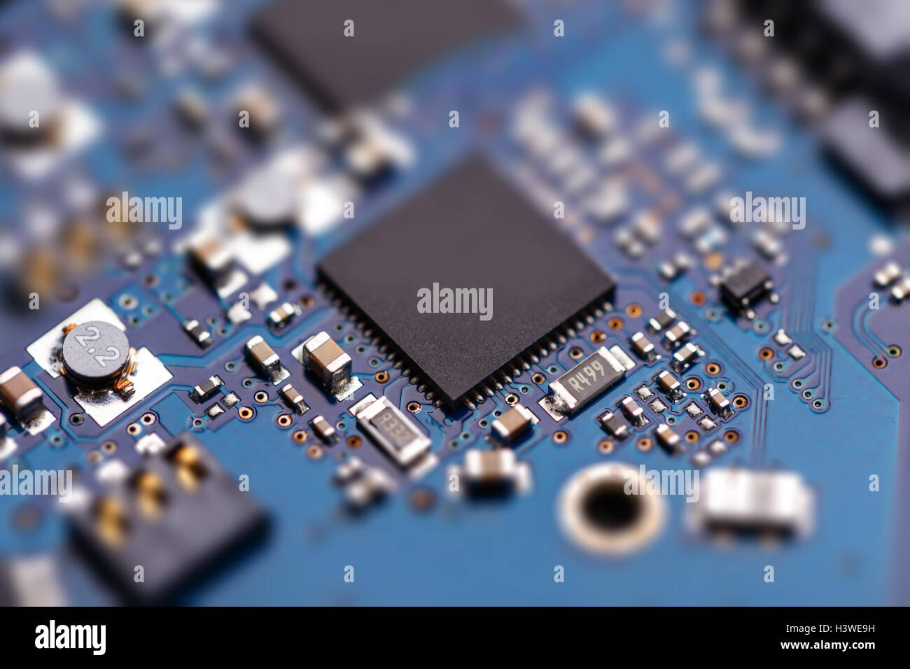 Integrated semiconductor microchip/ microprocessor on blue circuit board Stock Photo