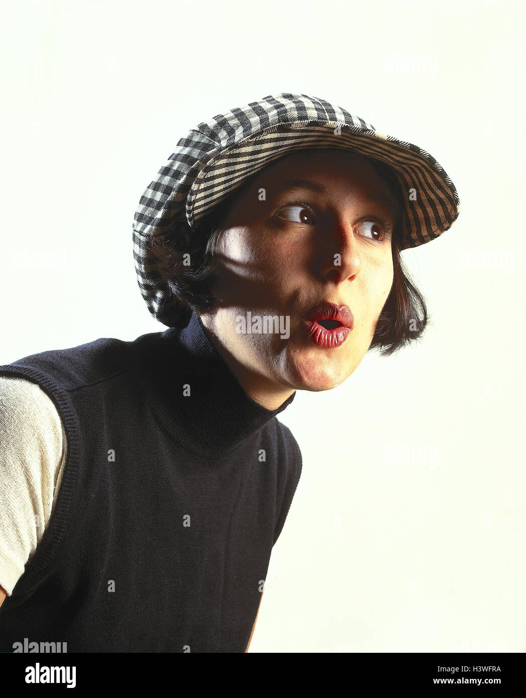 Woman, sign cap, facial play, curiosity, portrait, inside, young