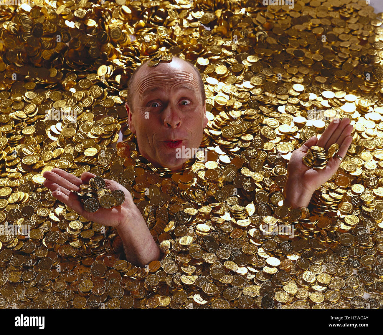 man-bathe-golden-coins-money-gold-wealth-swim-facial-play-joy-wealth-H3WGAY.jpg