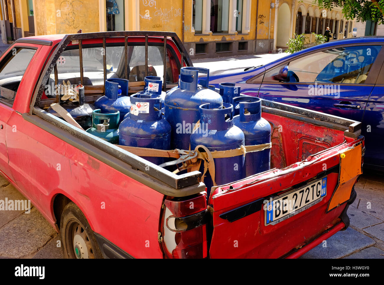 gas bottles strapped in back of old pick up truck, sardinia, italy Stock Photo