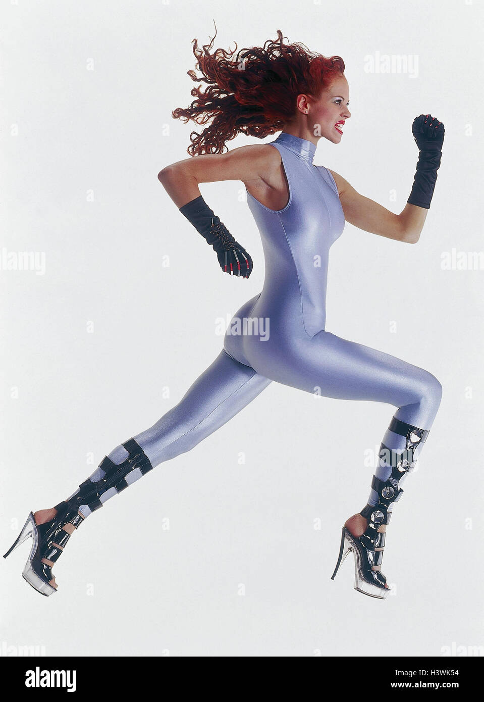 Woman, young, overall, silver, futuristic, stilettos, gloves, motion, run,  facial play Future, studio, inside, fashion, clothes, modern, run suit,  close-fitting, skintight, Highheels, long-haired, red, long-haired,  red-haired, make-up, future ...