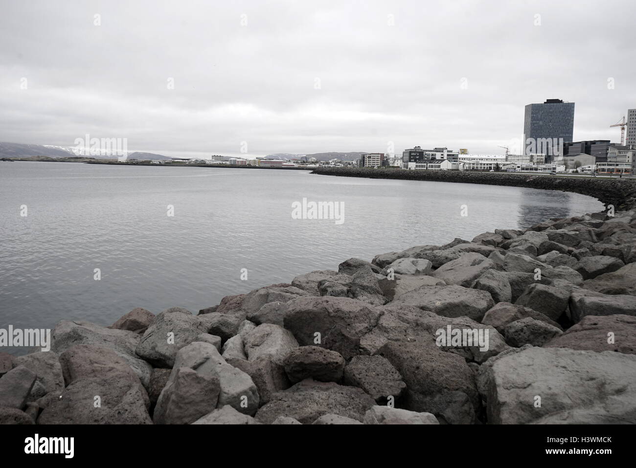Stone breaker barrage along the shores of Reykjavik Harbour, Iceland. Dated 21st Century Stock Photo