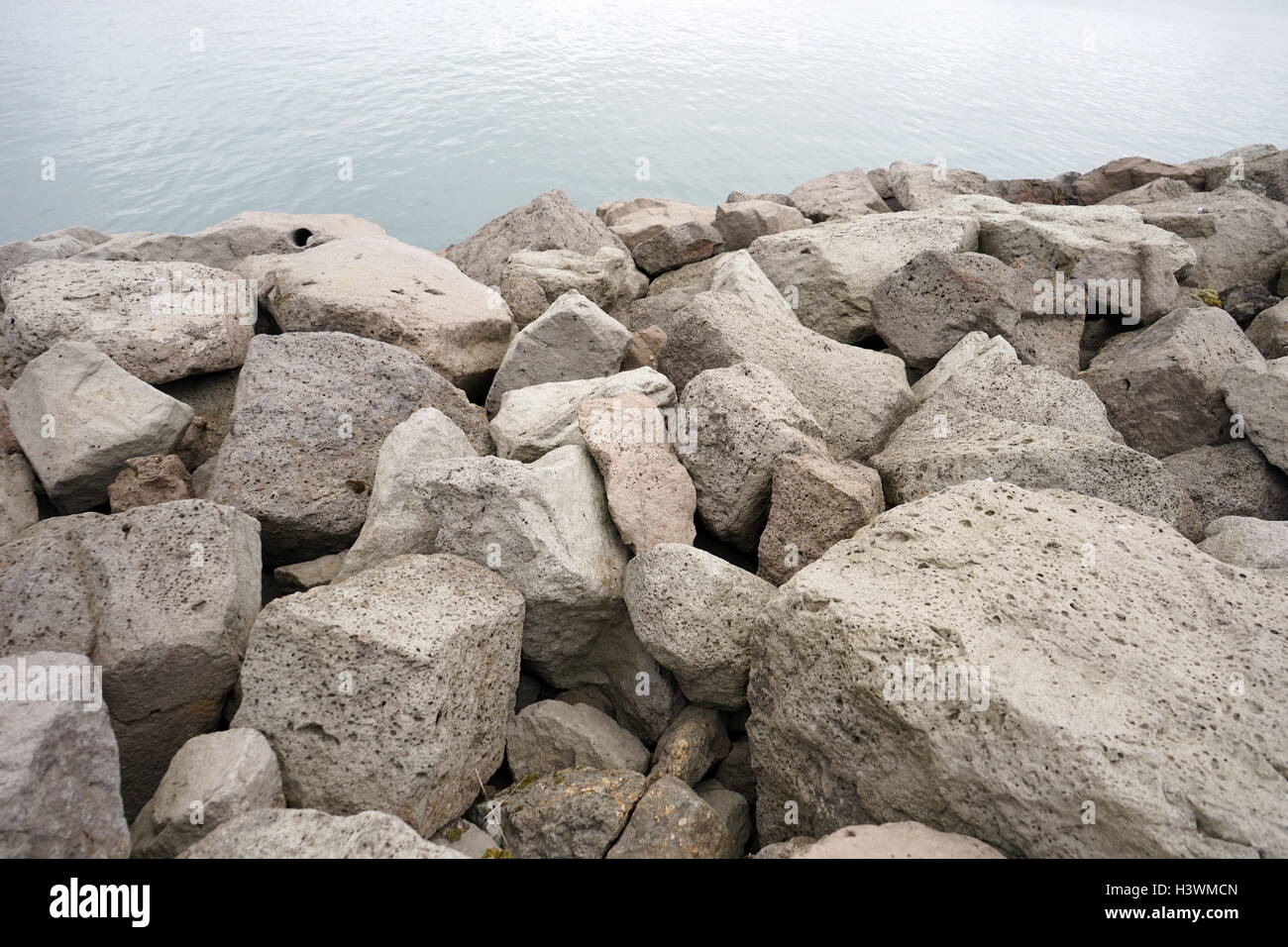 Stone breaker barrage along the shores of Reykjavik Harbour, Iceland. Dated 21st Century Stock Photo