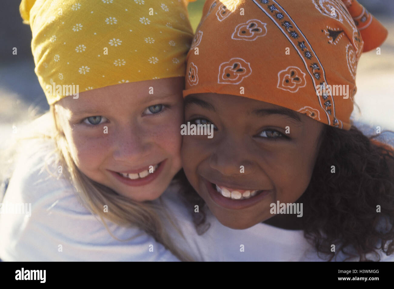 Girls, different colour of skin, headscarfs, laugh, embrace embrace, portrait, friends, friendship, friends, nationality, differently, non-whites, whiteness, children, blond, dark-haired, childhood, fun, cohesion, together, trust, suture, fun, happy, view Stock Photo