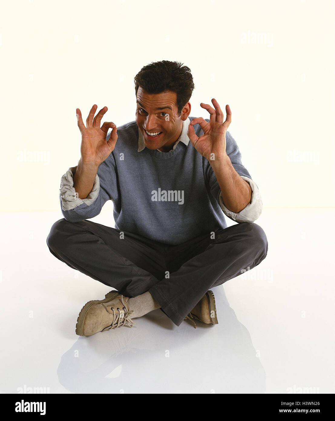 Man, young, cross legged, gesture, o.k Men, cut outs, studio, floor