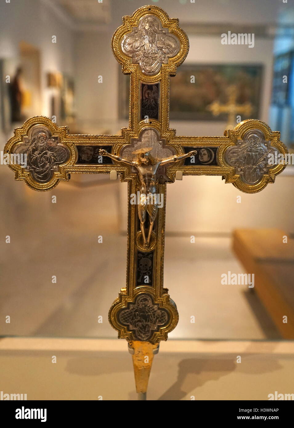 Partially gilded silver altar cross with Saint Francis, Saint Anthony of Padua and Saint Bernardino of Siena depicted. Dated 16th Century Stock Photo