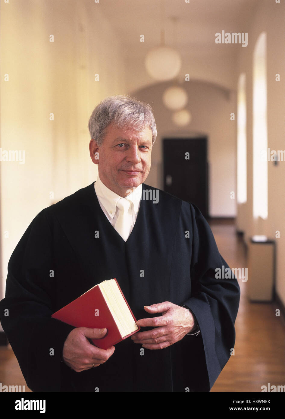 Sollicitor, code law, half portrait, man, occupation, lawyer, sollicitor, judge, court dress, justice, Jura, justice, Wahrheitsfindung, adjudication, view camera, smile, contently, seriously, courthouse, hall, inside Stock Photo