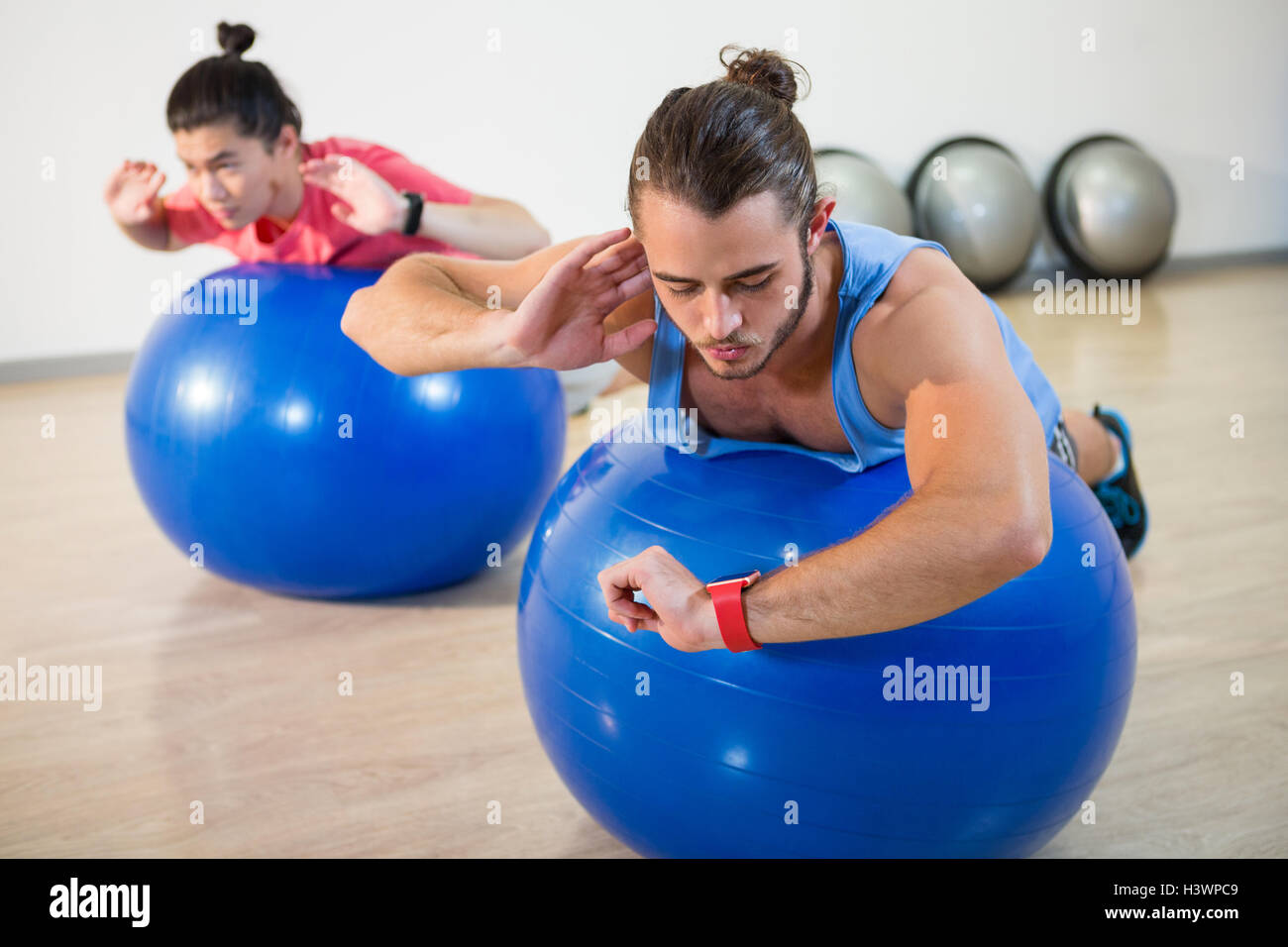 Men exercising on exercise ball Stock Photo