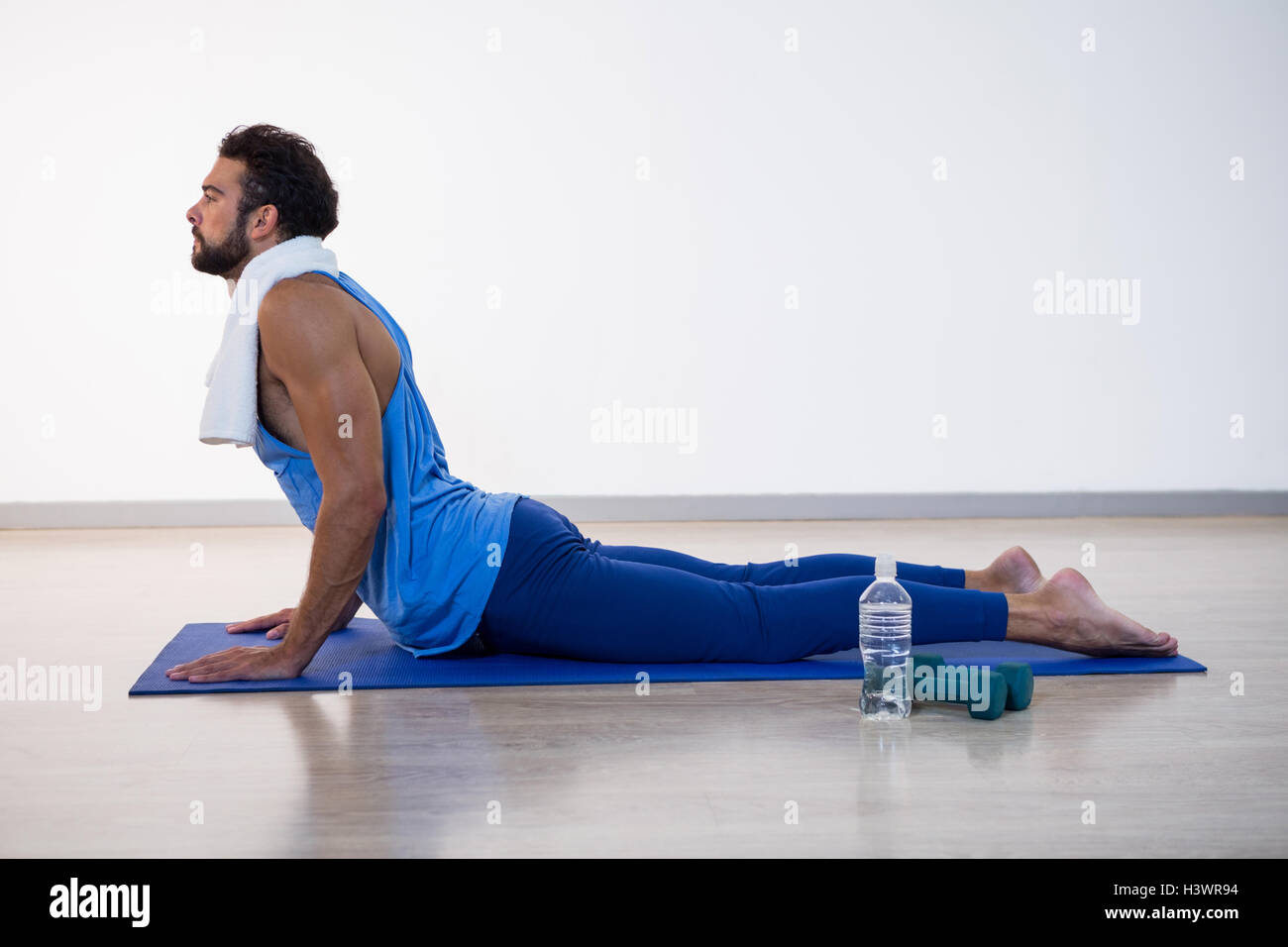 Man doing cobra pose on exercise mat Stock Photo - Alamy
