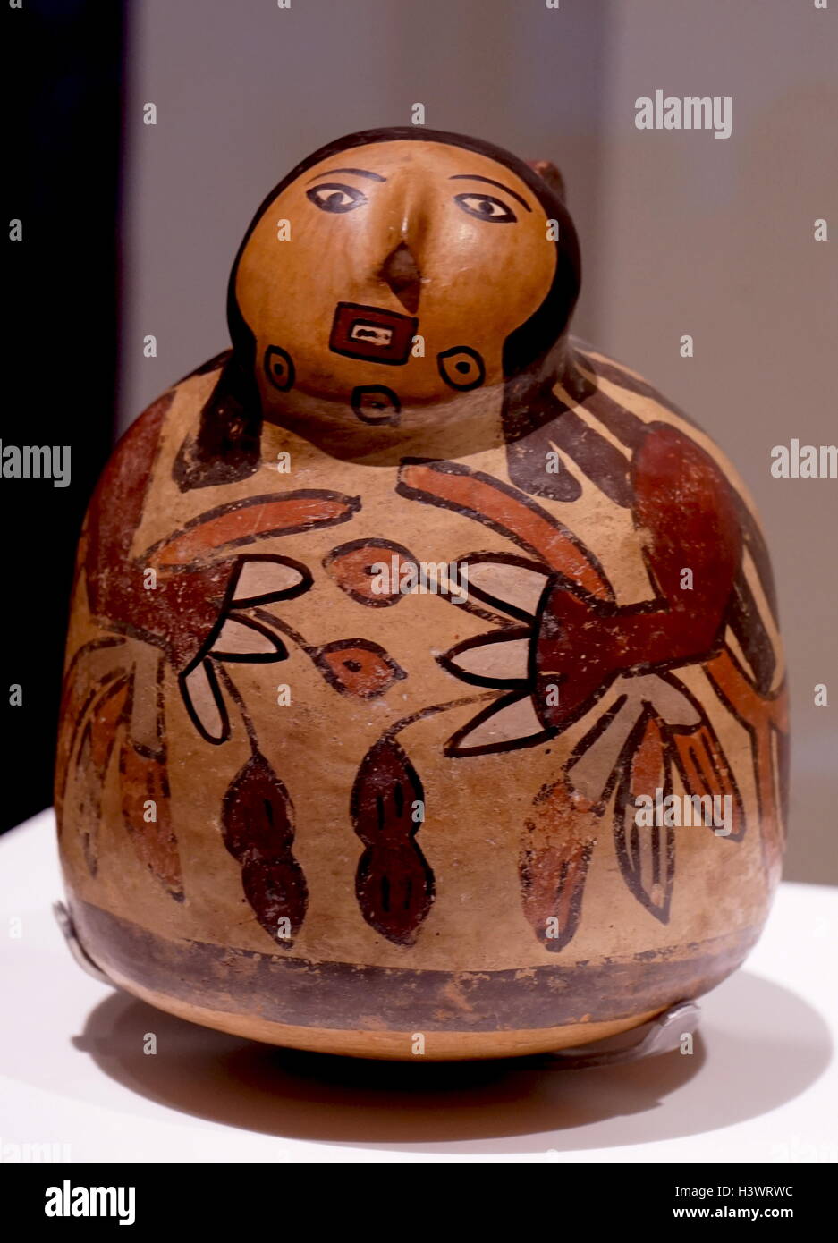 Ceramic bridge and spout vessel with a human figure with vegetal motifs. From Peru. Dated 3rd Century Stock Photo