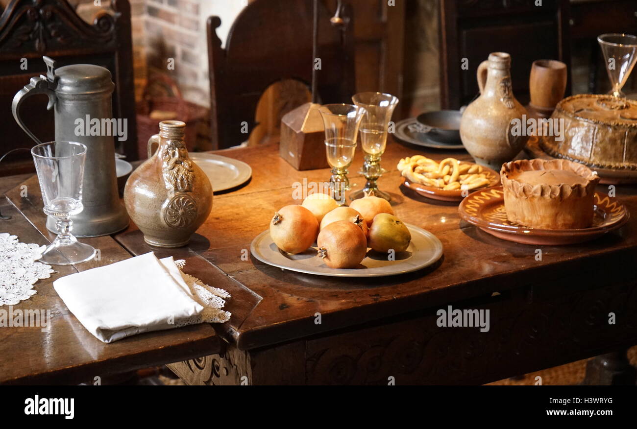 Elizabethan dining table set with typical foods, at Blakesley Hall is a Tudor hall on Blakesley Road, Yardley, Birmingham, England. It dates to 1590 Stock Photo