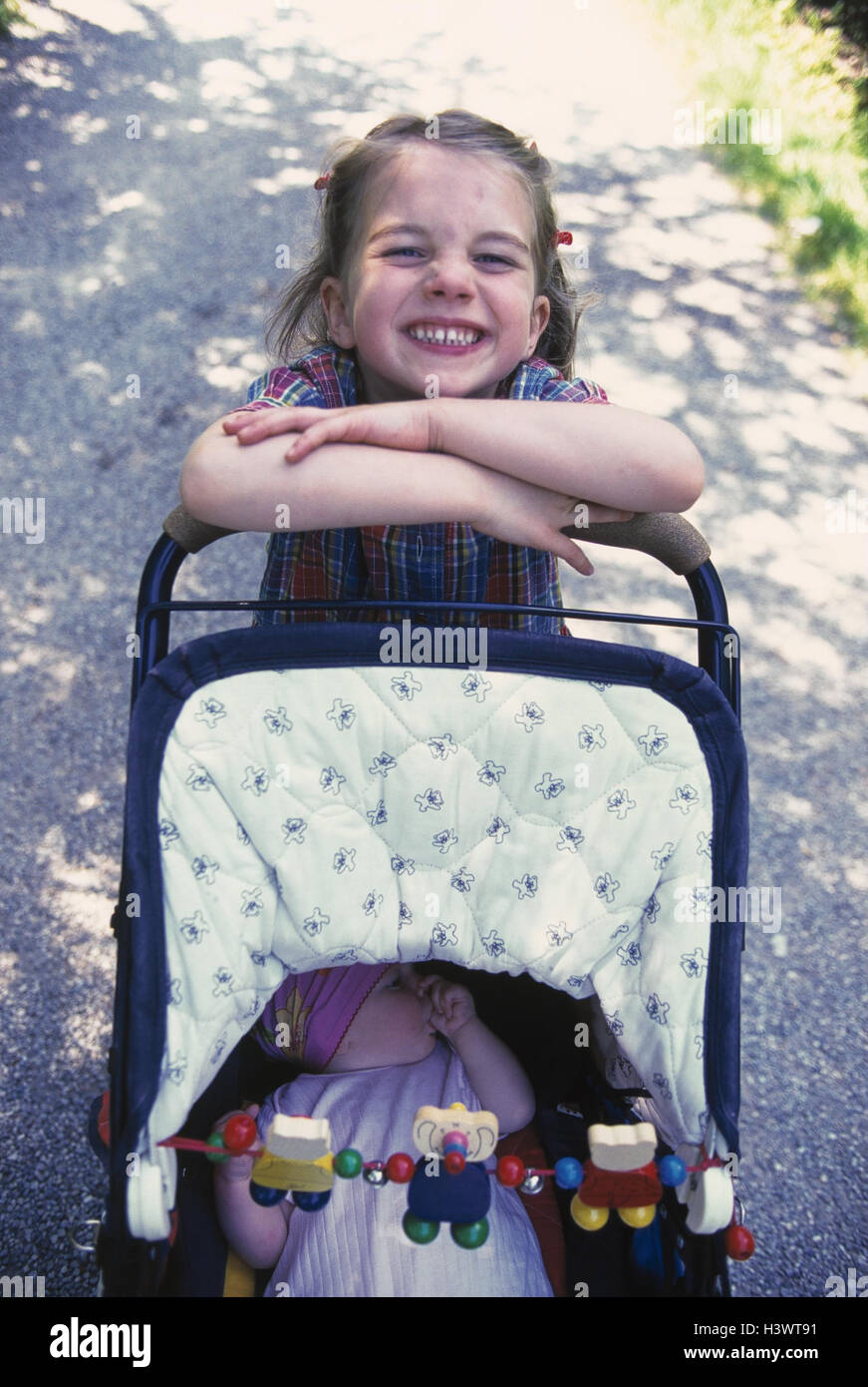 Park, way, girl, baby carriage, push, baby, pollex suck summer, child, childhood, happy, cheerfulness, grin, pride, sister, siblings, care, baby-sitting, baby sitter, suck Stock Photo